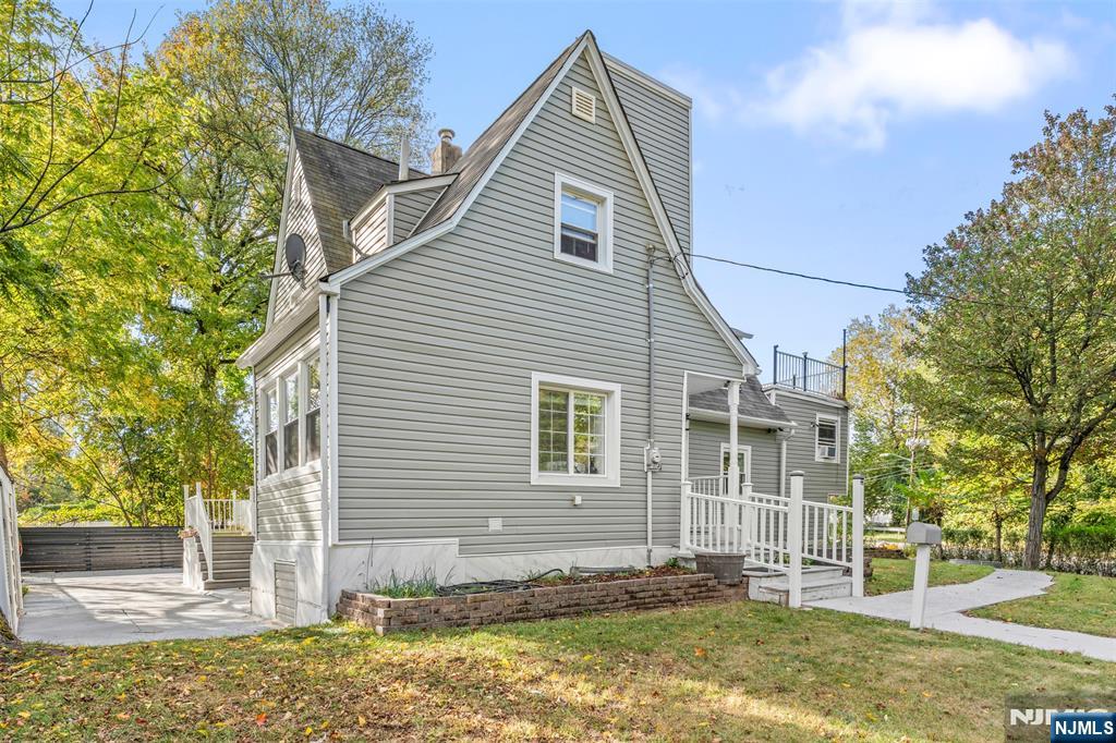 234 Liberty Road Teaneck, NJ 07666 - Photo 39 of 42 a view of a house with a yard and large tree