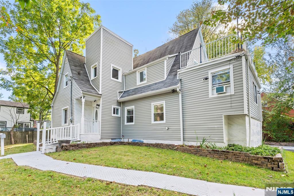 234 Liberty Road Teaneck, NJ 07666 - Photo 40 of 42 a front view of a house with a yard