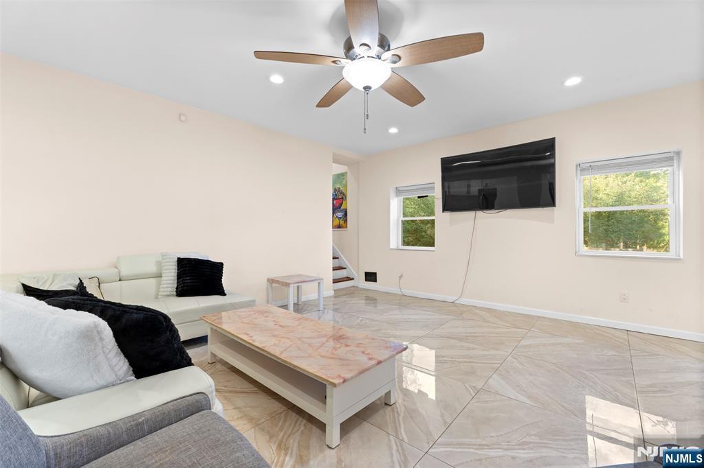 234 Liberty Road Teaneck, NJ 07666 - Photo 5 of 42 a living room with furniture and a flat screen tv