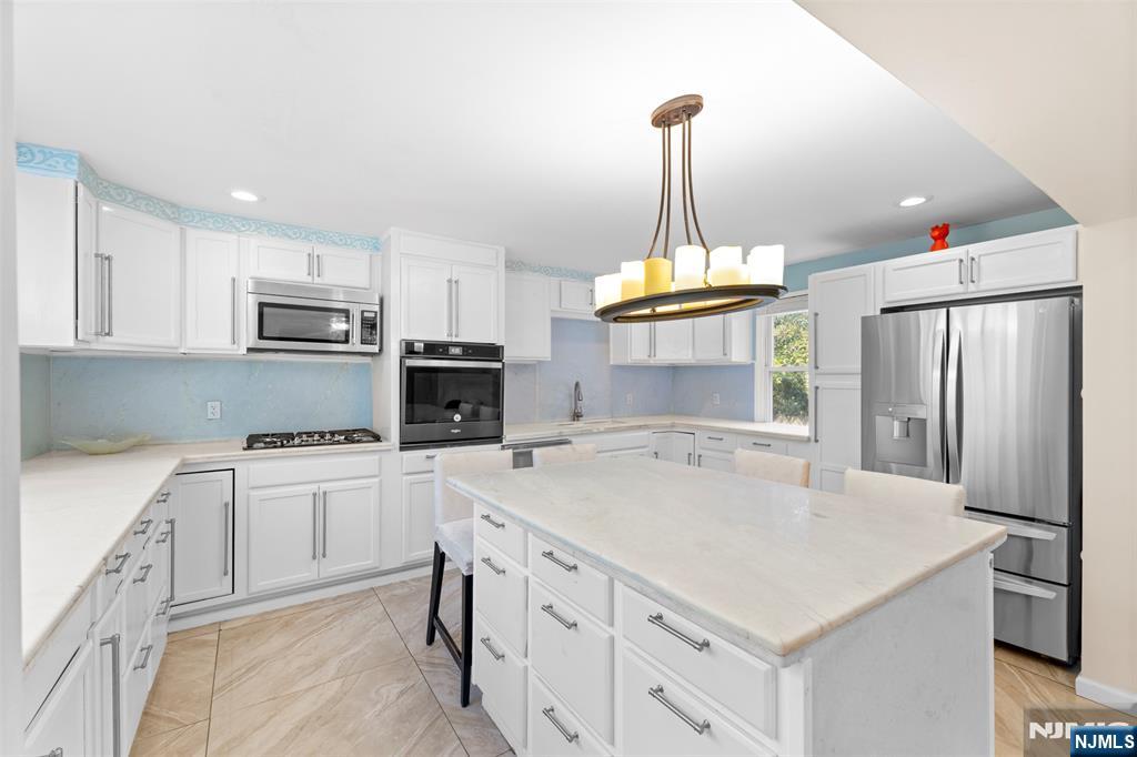 234 Liberty Road Teaneck, NJ 07666 - Photo 6 of 42 a kitchen with kitchen island a stove sink and refrigerator