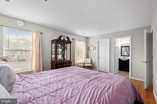 a bedroom with a large bed and dresser
