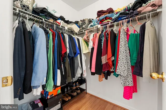 a view of walk in closet with clothes