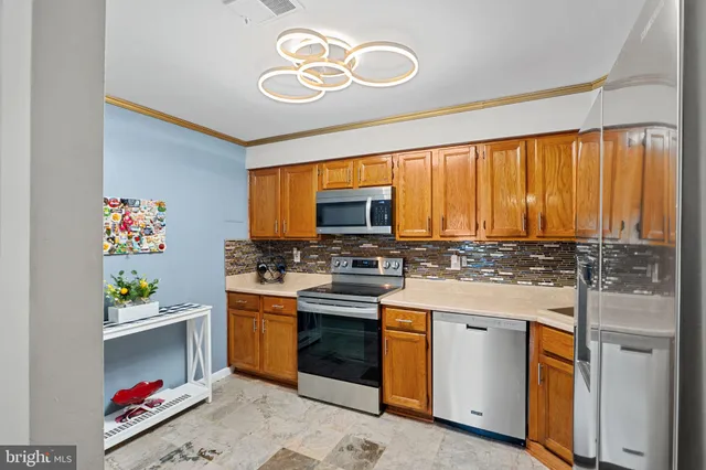 a kitchen with a stove a sink and a window