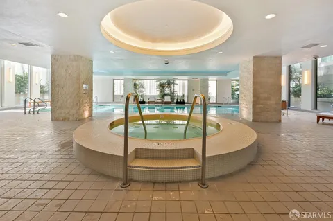 a spacious bathroom with a large tub and shower