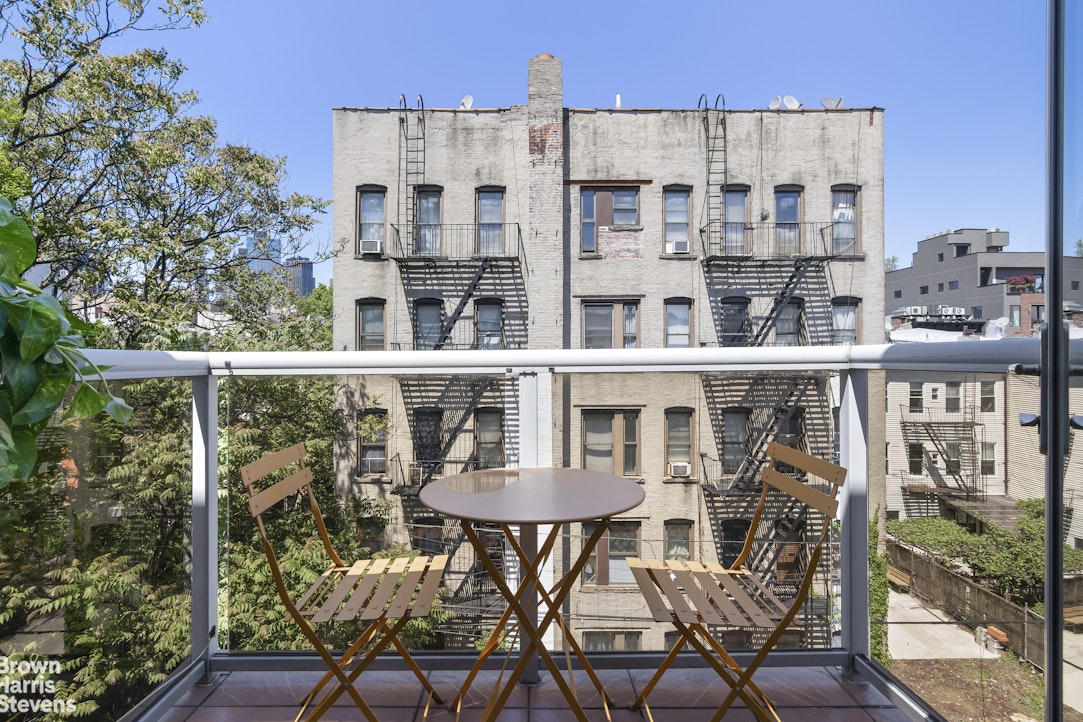 199 Huron Street, Unit 4D Brooklyn, NY 11222 - Photo 3 of 8 a view of a building from a chairs and table in the patio