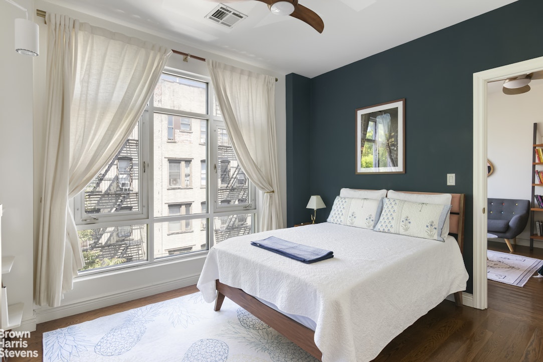 199 Huron Street, Unit 4D Brooklyn, NY 11222 - Photo 5 of 8 a bedroom with a large bed and a large window