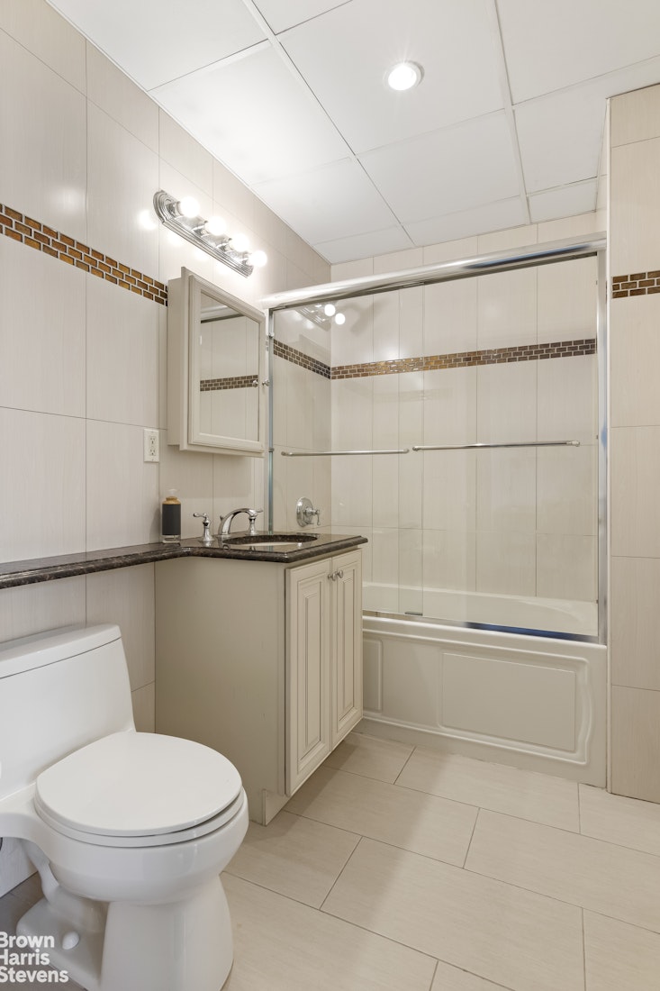 199 Huron Street, Unit 4D Brooklyn, NY 11222 - Photo 6 of 8 a bathroom with a toilet a sink and bathtub