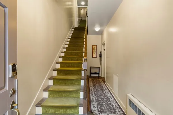 a view of entryway and gallery with wooden floor