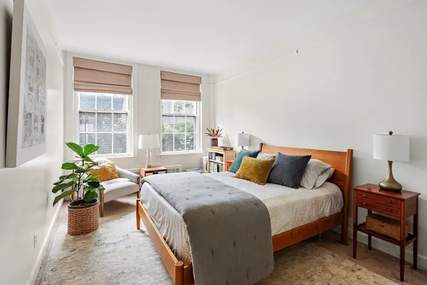 a bed room with a bed and a chair