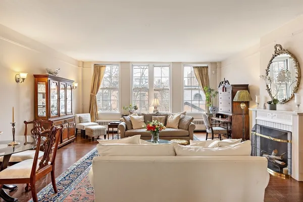 a living room with fireplace furniture and a large window