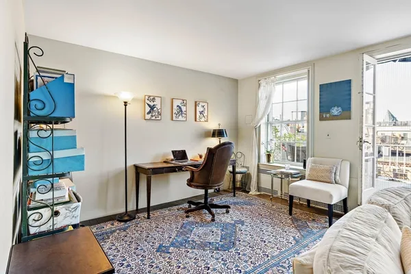a living room with furniture a rug and a window