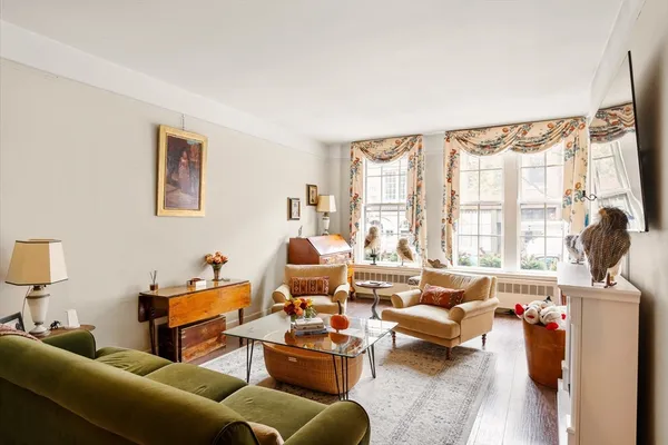 a living room with furniture wooden floor and a large window