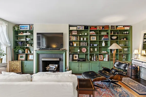 a living room with furniture a fireplace and a flat screen tv