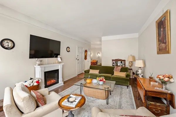 a living room with furniture a flat screen tv and a fireplace