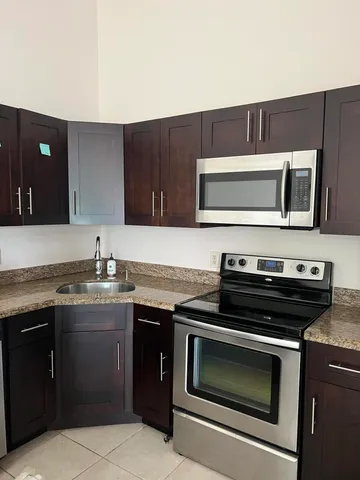 a kitchen with a stove and a microwave