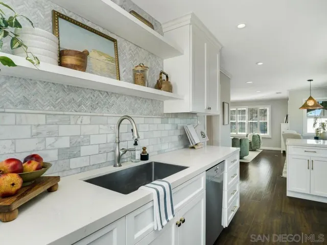 a kitchen with a sink and a stove top oven