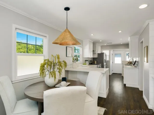 a living room with furniture a window and kitchen view