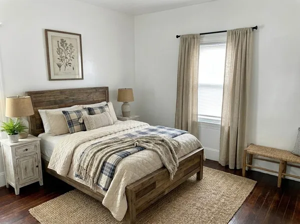 a bed sitting in a bedroom next to a window
