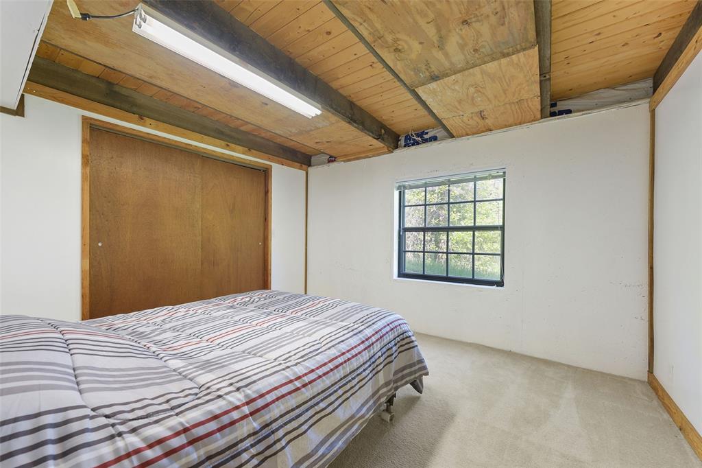 821 Ewing Road Ferris, TX 75125 - Photo 20 of 40 a bedroom with a bed and a window