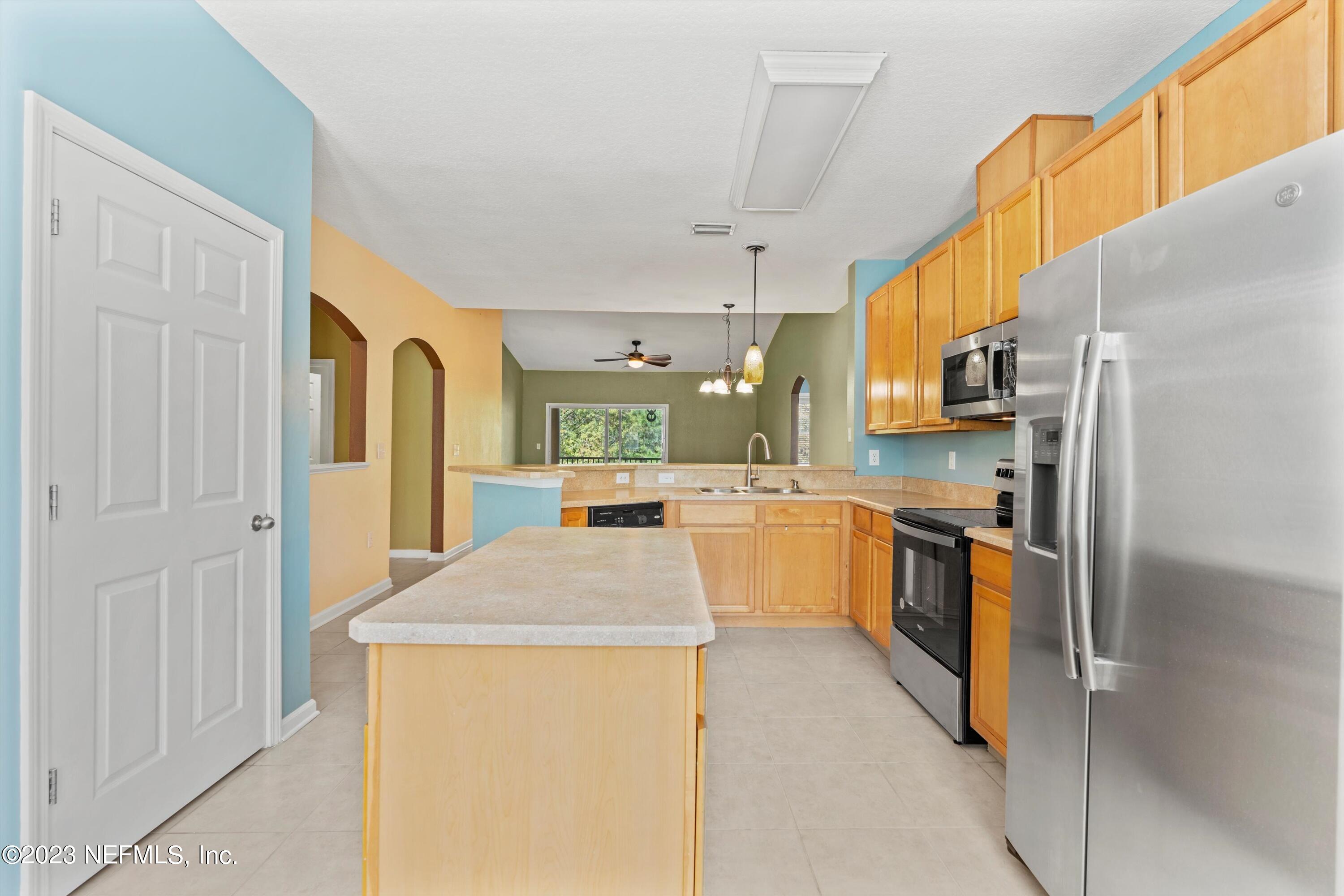 5663 Greenland Road, Unit 1005 Jacksonville, FL 32258 - Photo 14 of 30 a kitchen with stainless steel appliances a refrigerator a sink dishwasher stove and oven