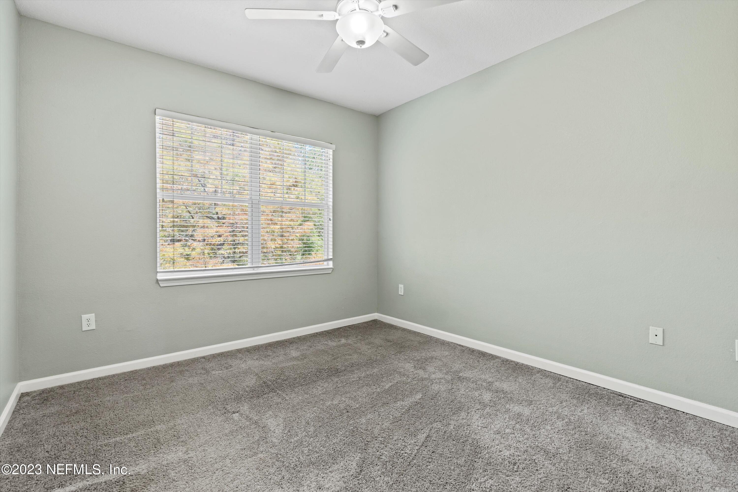 5663 Greenland Road, Unit 1005 Jacksonville, FL 32258 - Photo 17 of 30 an empty room with a window and a ceiling fan