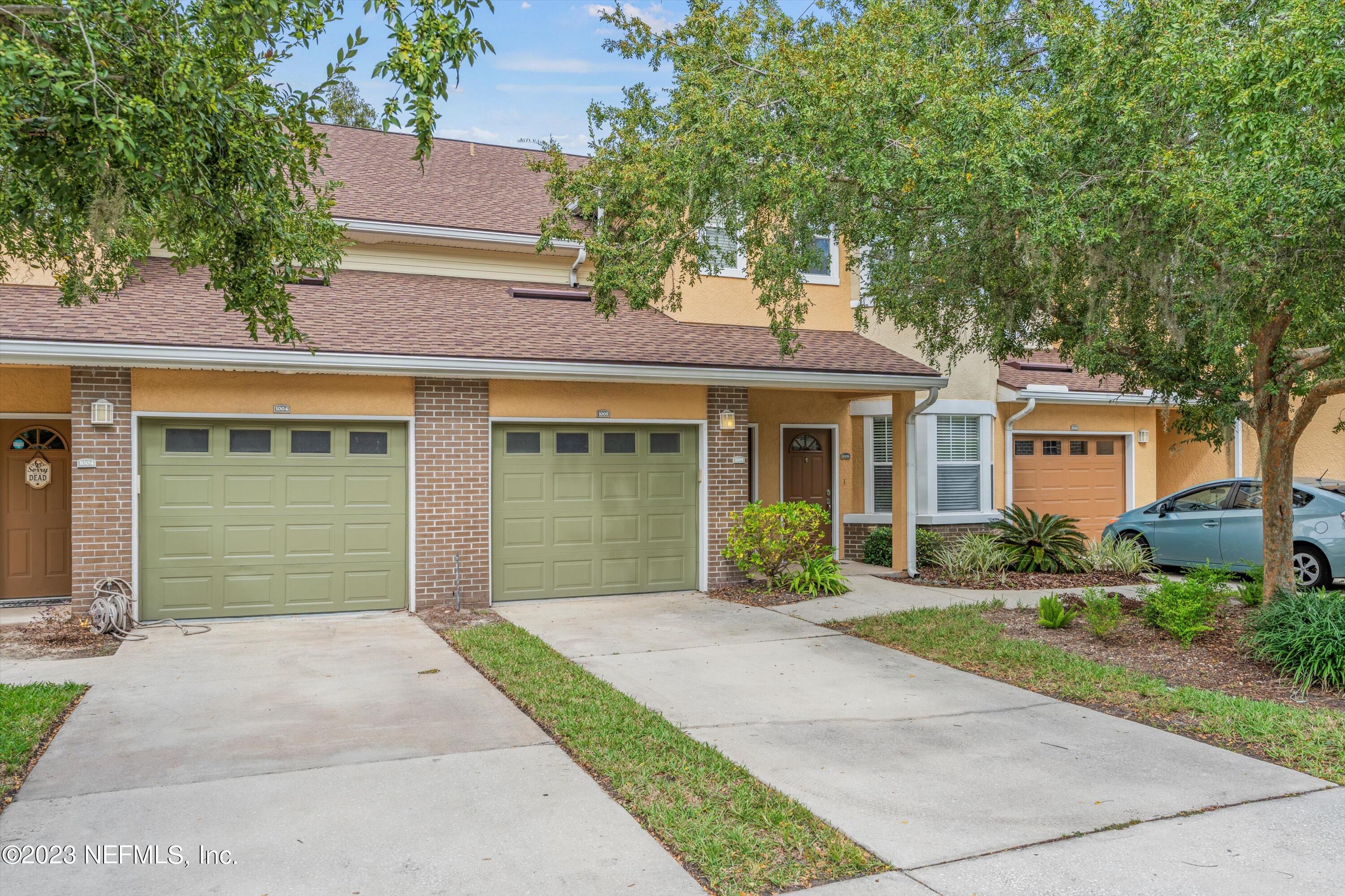 5663 Greenland Road, Unit 1005 Jacksonville, FL 32258 - Photo 2 of 30 front view of a brick house with a yard