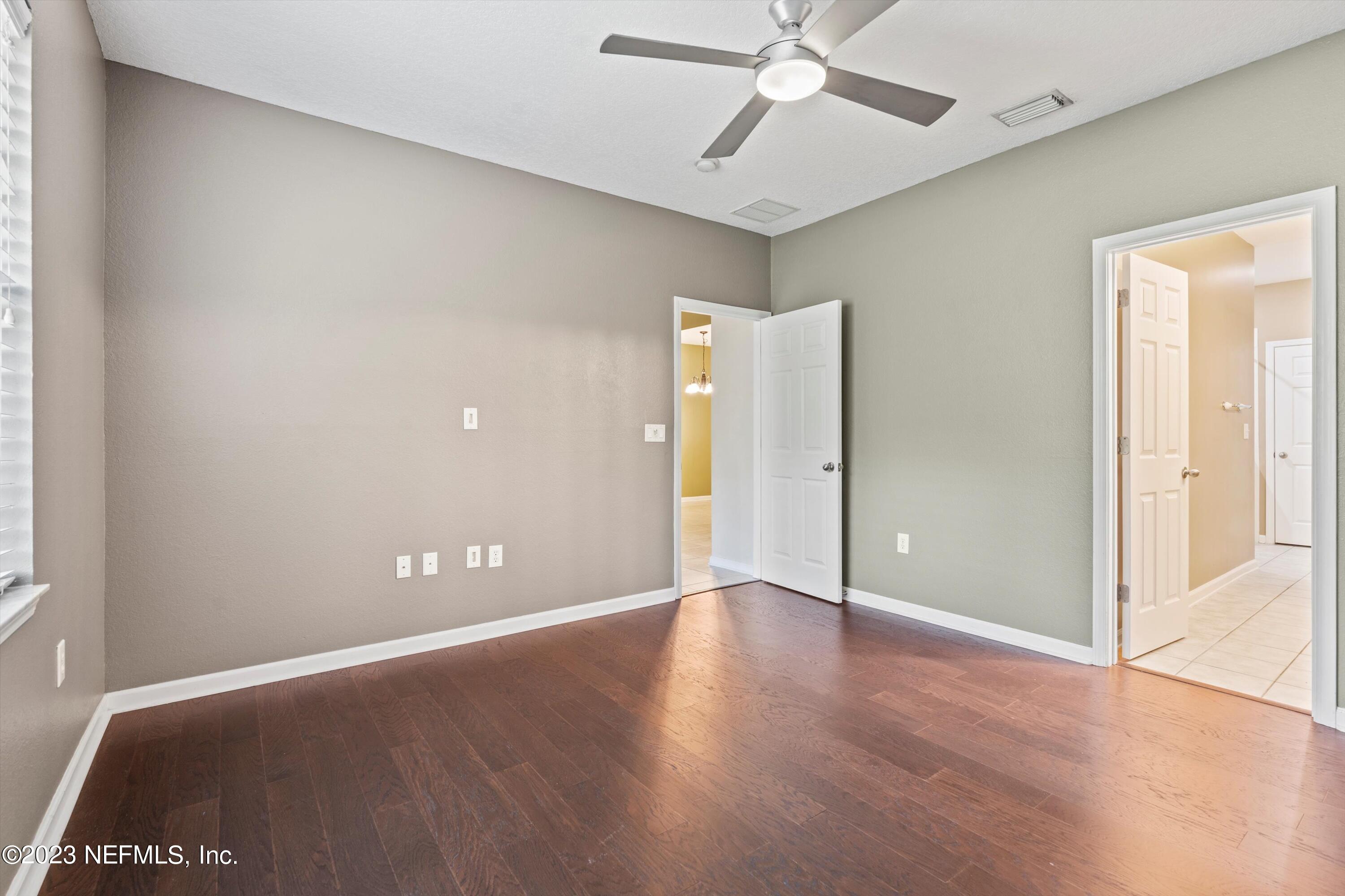 5663 Greenland Road, Unit 1005 Jacksonville, FL 32258 - Photo 21 of 30 an empty room with wooden floor and windows