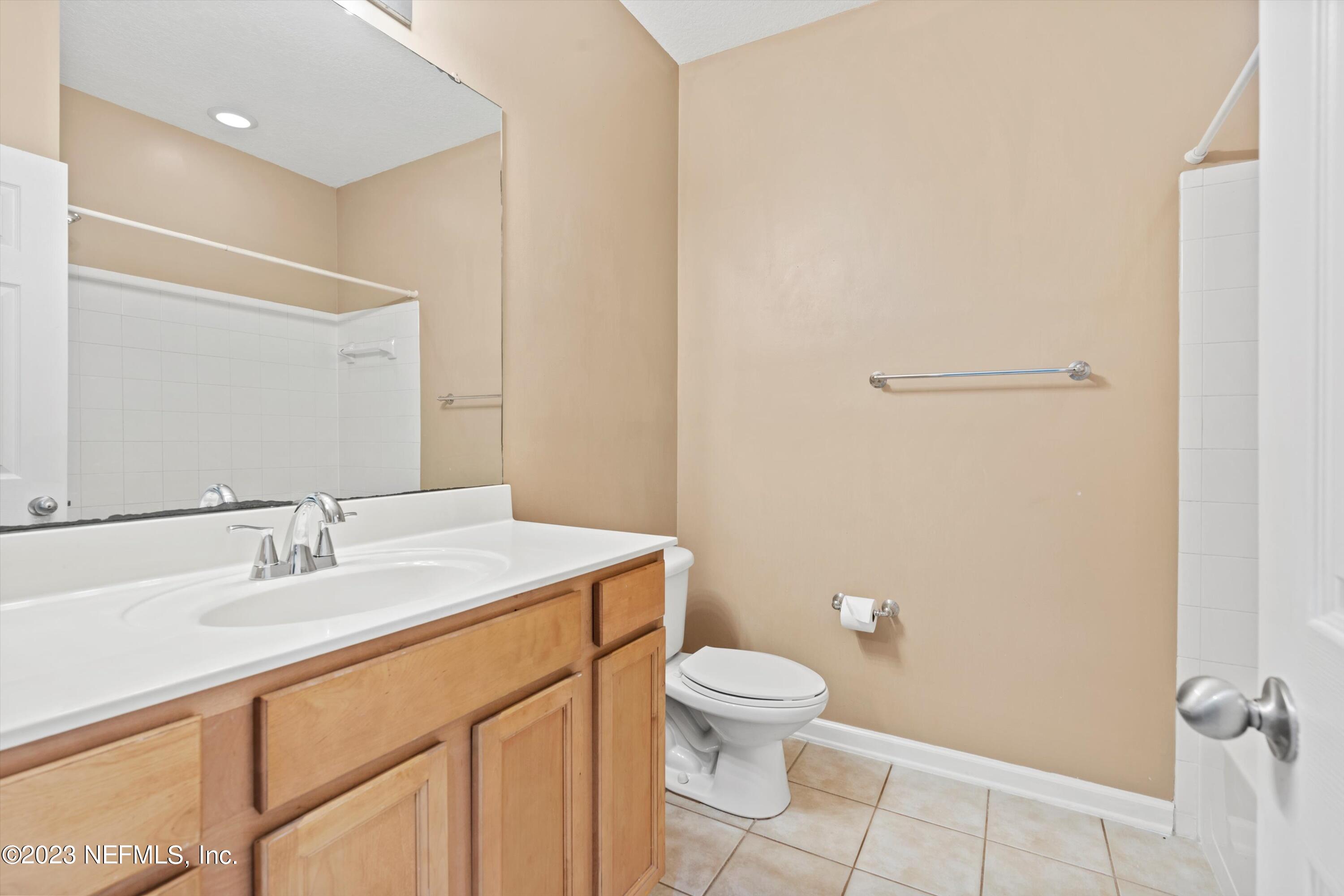 5663 Greenland Road, Unit 1005 Jacksonville, FL 32258 - Photo 27 of 30 a bathroom with a sink a toilet and a mirror
