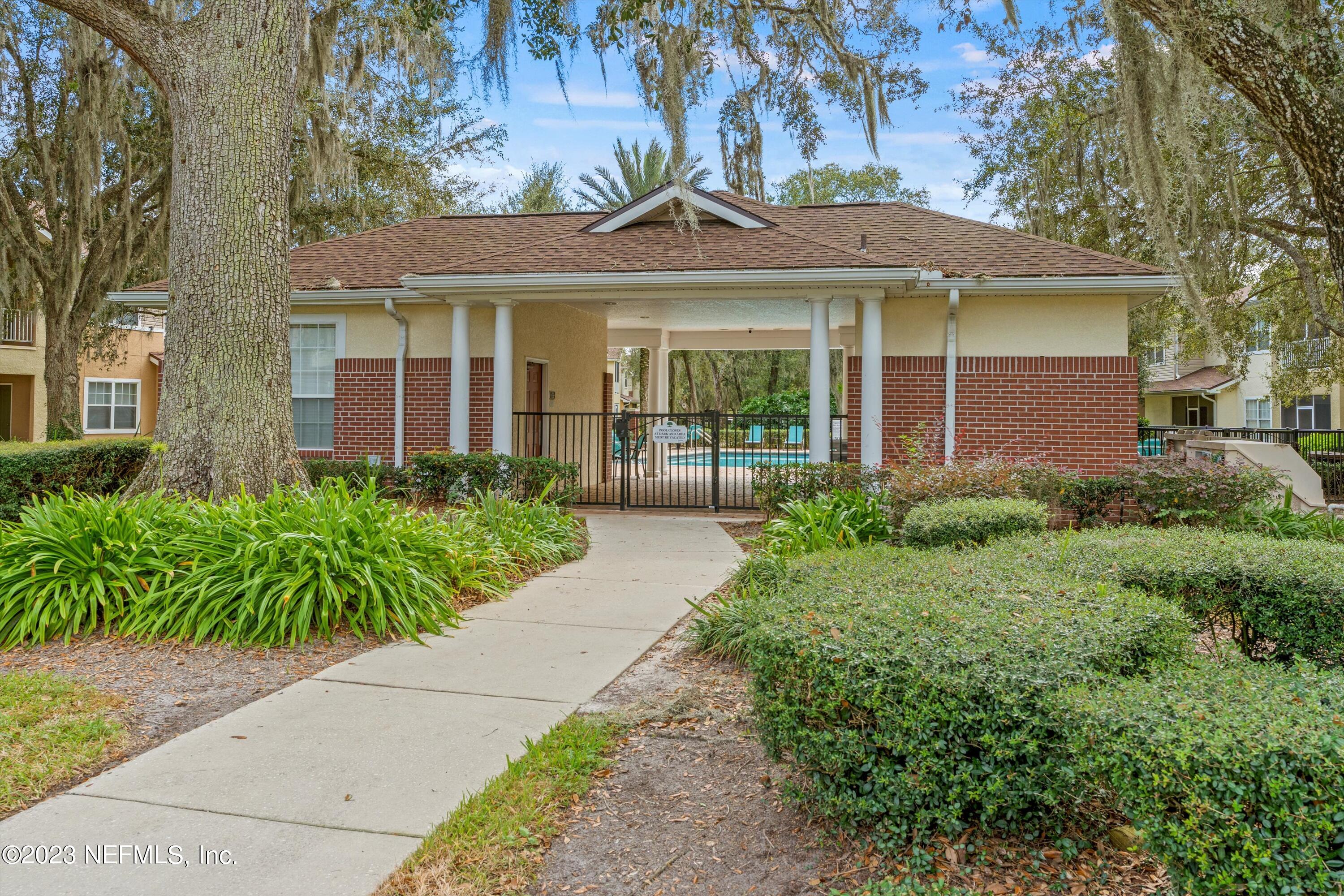 5663 Greenland Road, Unit 1005 Jacksonville, FL 32258 - Photo 5 of 30 front view of a brick house with a large window