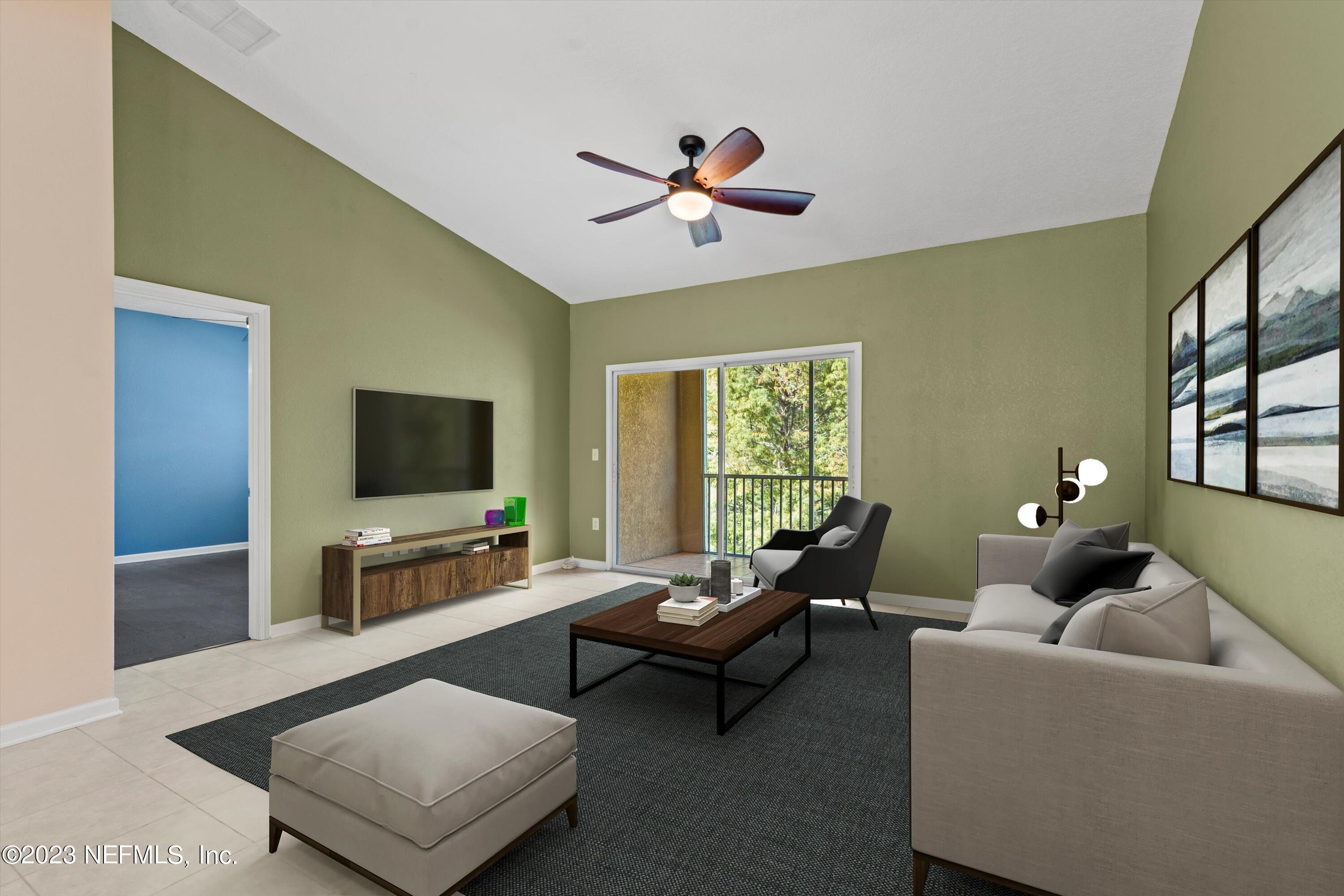 5663 Greenland Road, Unit 1005 Jacksonville, FL 32258 - Photo 9 of 30 a living room with furniture and a flat screen tv