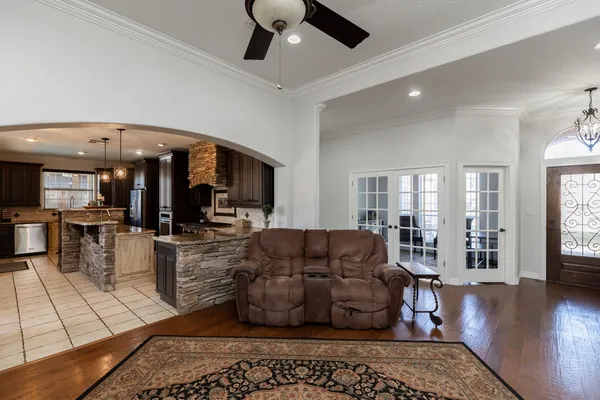 a living room with furniture and wooden floor