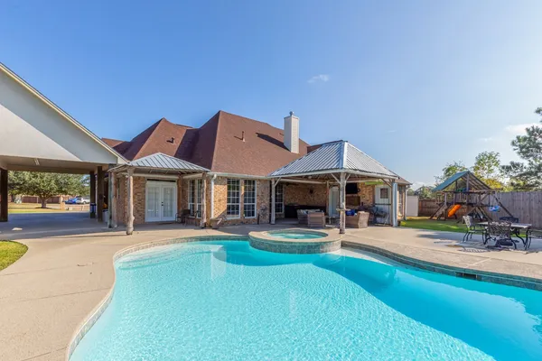 a view of a house with sitting area and garden