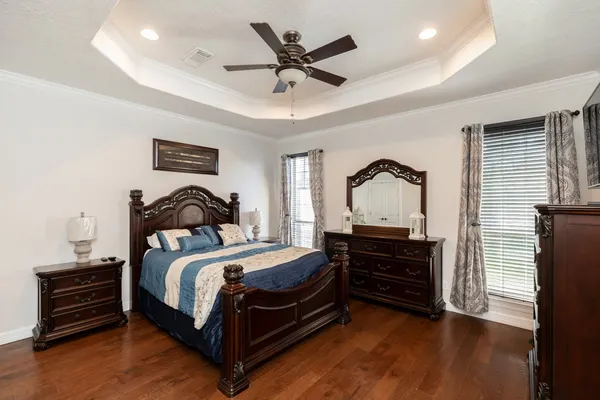 a bedroom with a bed and a ceiling fan