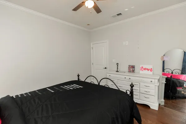 a bedroom with a bed and a dresser