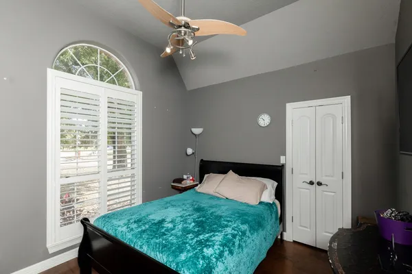 a bedroom with a bed and a window