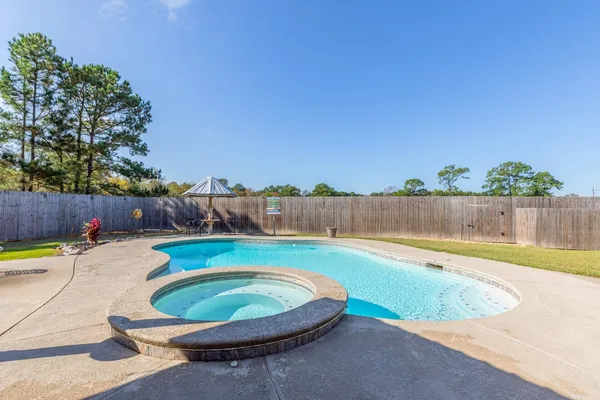 a view of a swimming pool with a patio