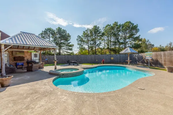 a view of a swimming pool with a patio