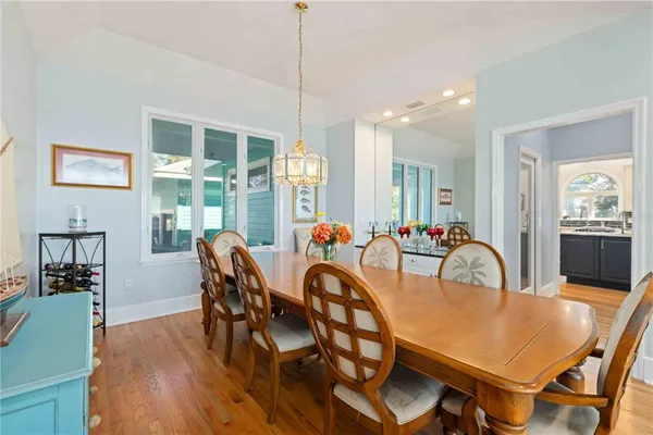 a living room with furniture a flat screen tv and wooden floor