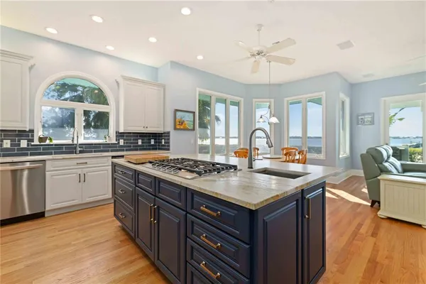 a view of a kitchen with sink stove and oven
