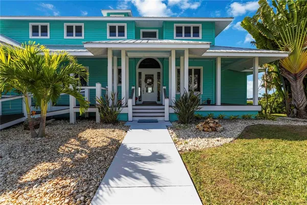 a aerial view of a house with a yard and lake view