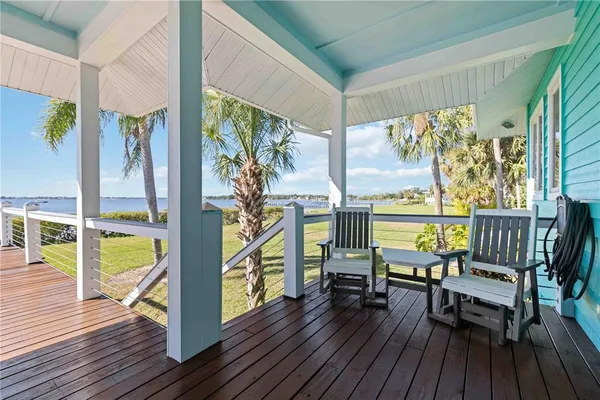 a aerial view of a house with a yard and lake view