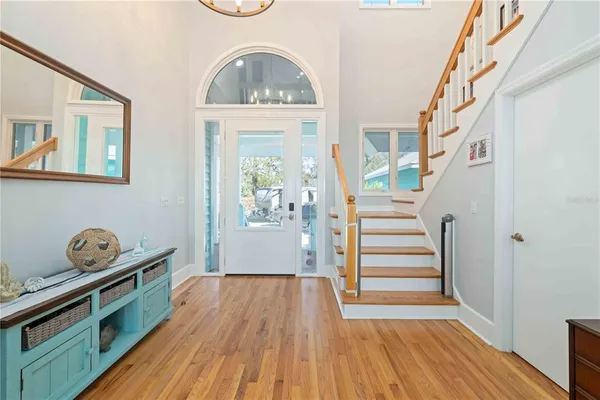 a living room with furniture a rug and a floor to ceiling window