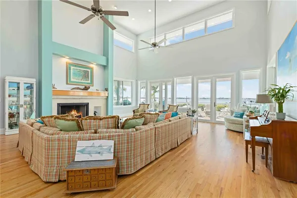 a living room with furniture a fireplace and a floor to ceiling window