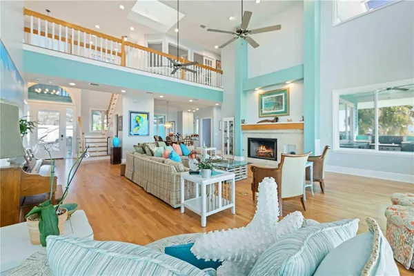 a dining room with furniture a chandelier and wooden floor