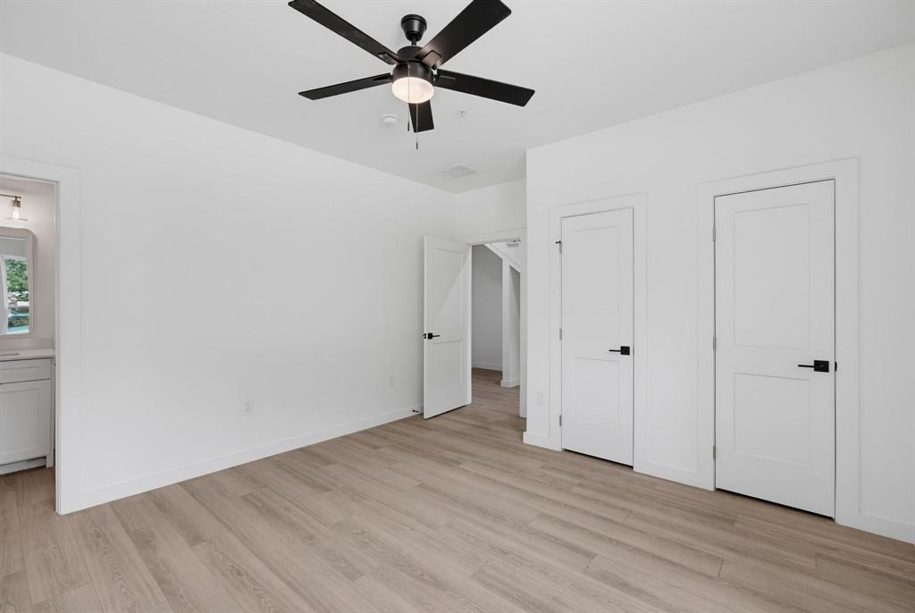 510 South O Connor Road Irving, TX 75060 - Photo 7 of 22 Bright room featuring wood-finish flooring and a black ceiling fan with integrated lighting
