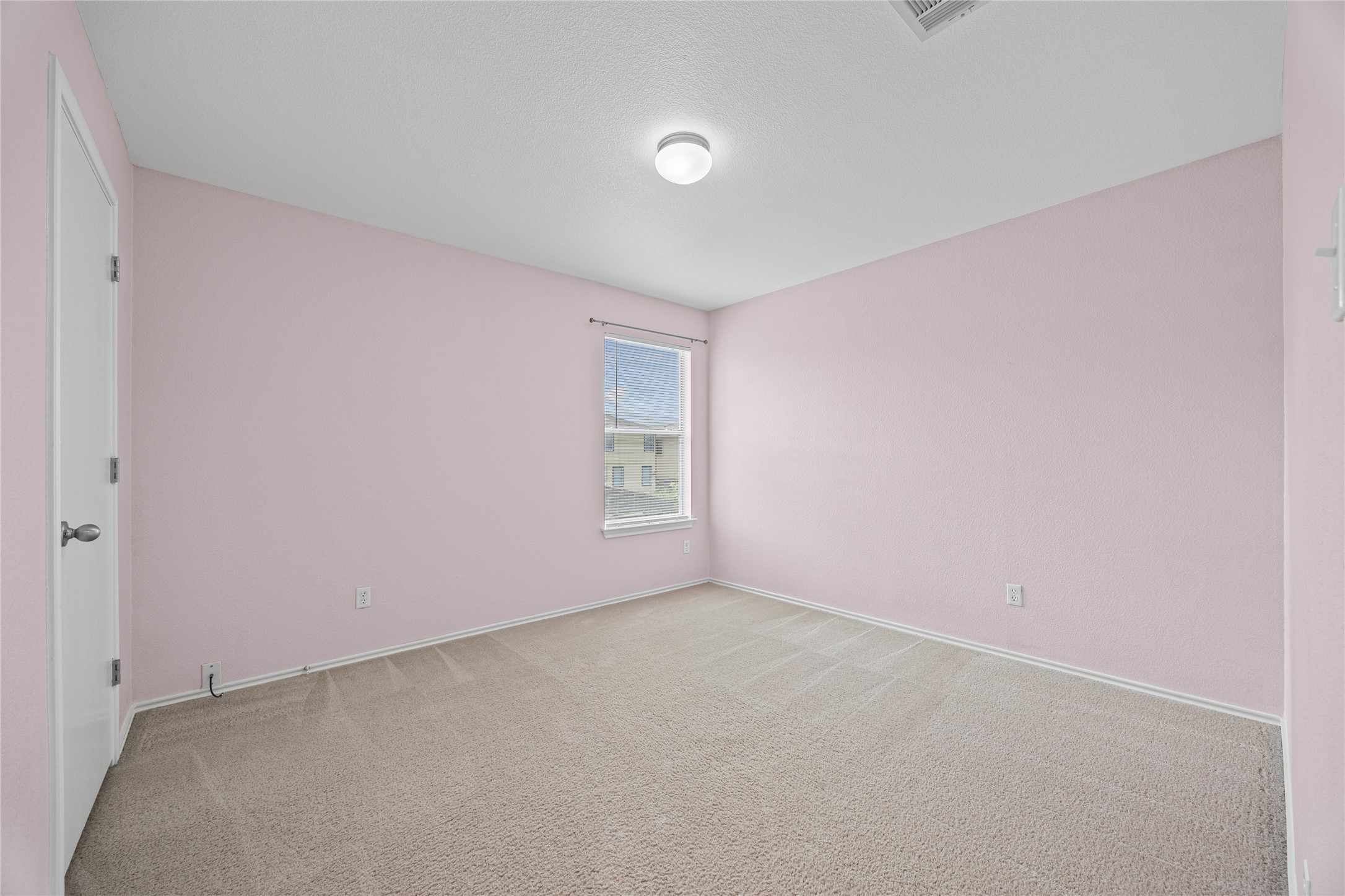 198 Black Forest Road Buda, TX 78610 - Photo 12 of 23 A well-lit bedroom with soft-toned walls and comfortable carpet flooring awaits your personal touch.