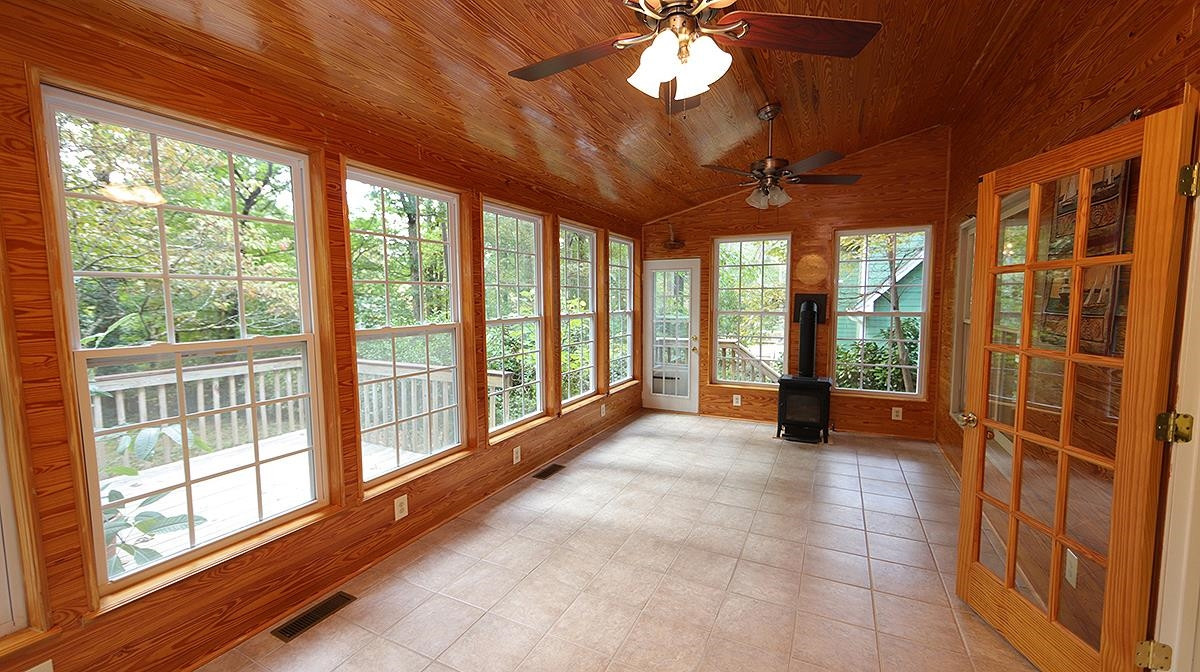 8700 Mourning Dove Road Raleigh, NC 27615 - Photo 17 of 30 Most certain to be a favorite spot in the home! Absolutely gorgeous walls and ceiling and private wooded back lot to enjoy the natural setting. Step out from here onto the deck if you like. Sun Room