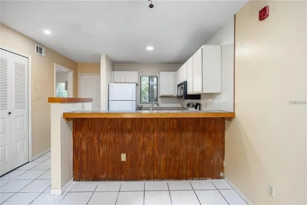 a view of kitchen with granite countertop cabinets