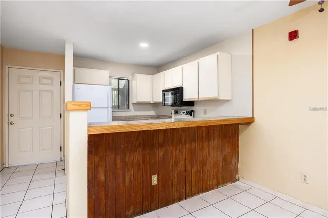 a kitchen with stainless steel appliances a refrigerator and microwave