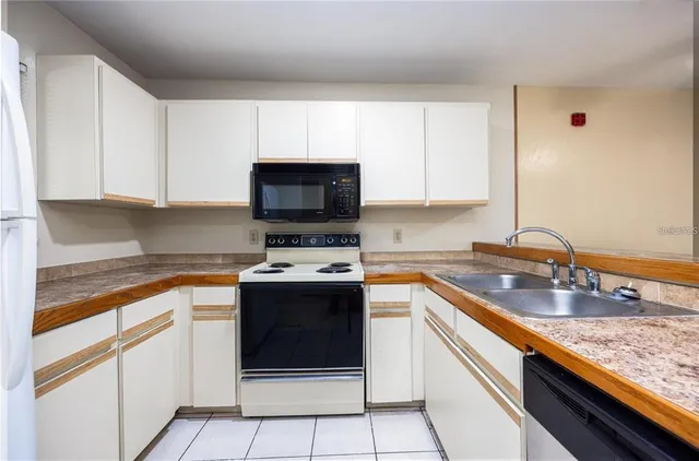 a kitchen with stainless steel appliances granite countertop a sink stove and microwave
